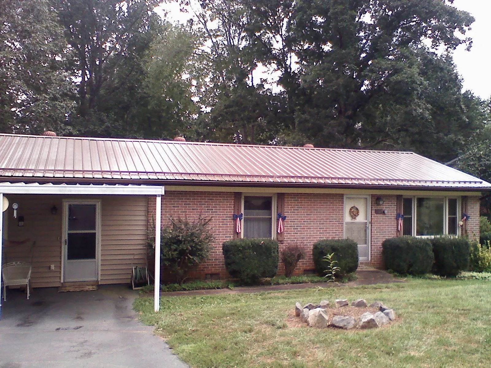 Bronze metal roof and carport on a brick ranch home — Roof Repair work by our crew in Mequon